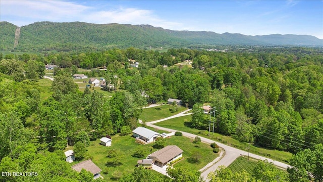 bird's eye view featuring a forest view and a mountain view