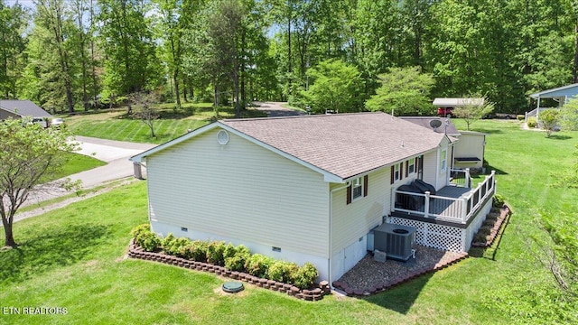 view of property exterior with a wooden deck, a shingled roof, crawl space, a lawn, and central air condition unit
