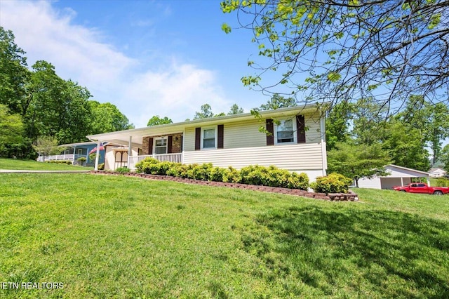 ranch-style home featuring covered porch, a front yard, and a carport
