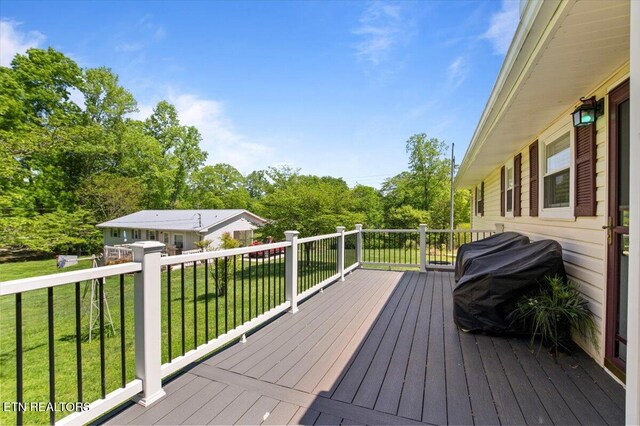 wooden terrace with a yard