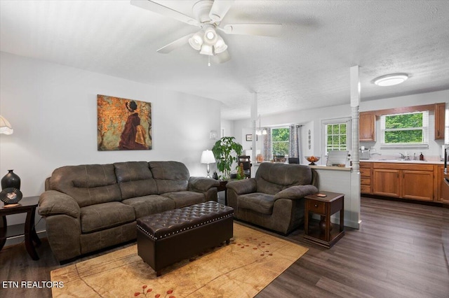 living room featuring a ceiling fan and wood finished floors