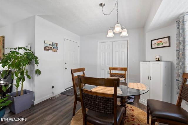dining room featuring baseboards, an inviting chandelier, and dark wood-style floors