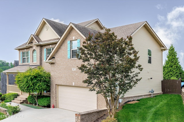 1827 Autumn Bluff Rd, Knoxville, TN 37932 - view of front of property featuring an attached garage, driveway, brick siding, and roof with shingles
