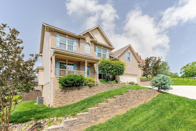 1827 Autumn Bluff Rd, Knoxville, TN 37932 - view of front of house featuring brick siding, an attached garage, driveway, cooling unit, and a porch