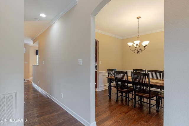 1827 Autumn Bluff Rd, Knoxville, TN 37932 - dining room featuring arched walkways, dark wood-type flooring, ornamental molding, a chandelier, and baseboards