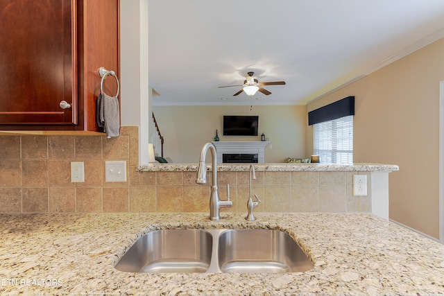 1827 Autumn Bluff Rd, Knoxville, TN 37932 - kitchen with a sink, ceiling fan, crown molding, tasteful backsplash, and light stone countertops
