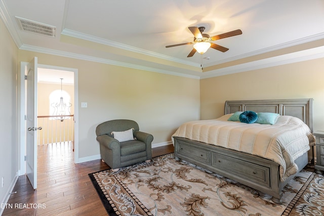 1827 Autumn Bluff Rd, Knoxville, TN 37932 - bedroom featuring hardwood / wood-style floors, baseboards, a tray ceiling, ornamental molding, and a chandelier