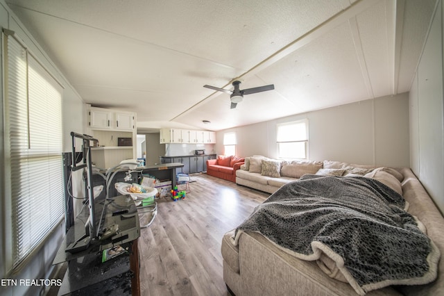 living room with ceiling fan and light wood finished floors