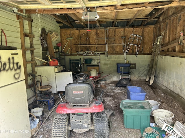 3510 Briceville Hwy, Briceville, TN 37710 - garage with freestanding refrigerator, concrete block wall, and a garage door opener