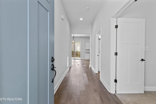 hallway featuring recessed lighting, dark wood-style flooring, and baseboards