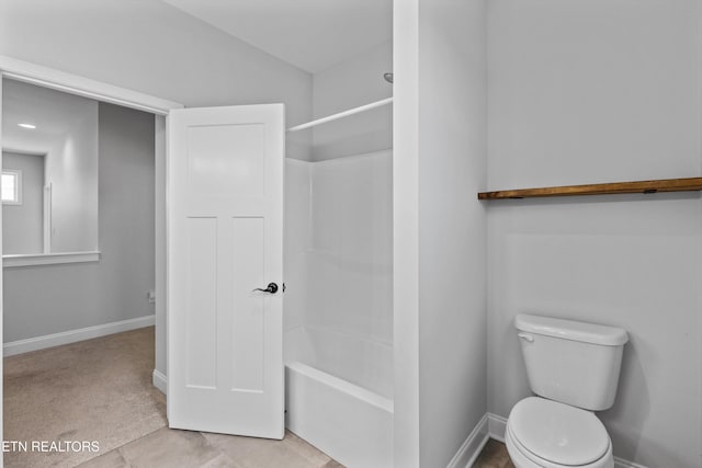 full bath with baseboards, toilet, and shower / washtub combination