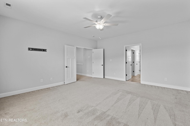 unfurnished bedroom with baseboards, ceiling fan, light carpet, and visible vents