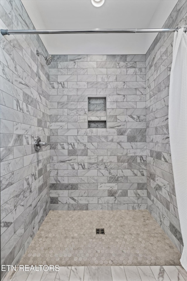 full bathroom with tiled shower