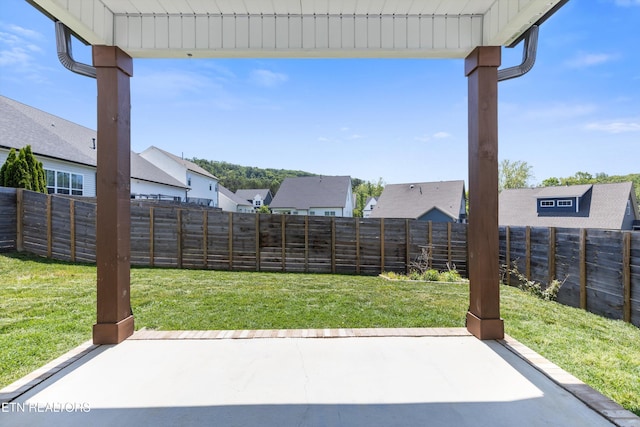 view of yard with a fenced backyard, a patio area, and a residential view