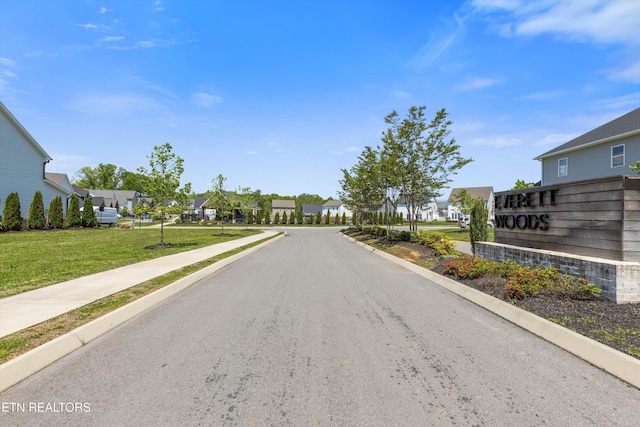 view of street featuring curbs, sidewalks, and a residential view