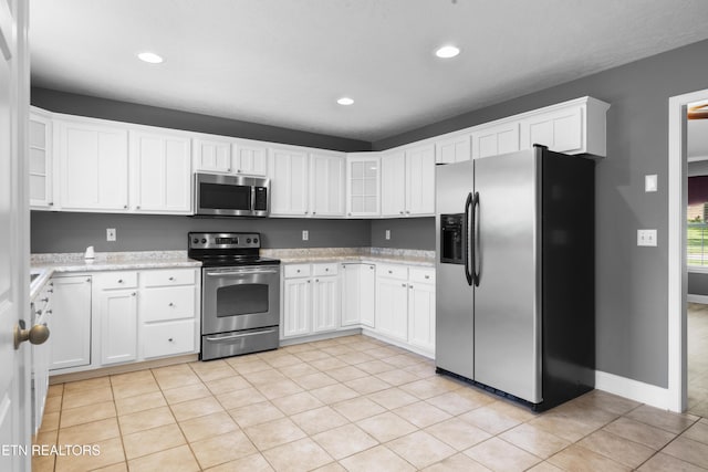 kitchen featuring recessed lighting, white cabinetry, and appliances with stainless steel finishes