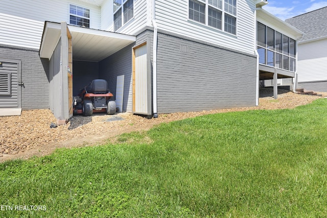 view of property exterior with a sunroom and a yard