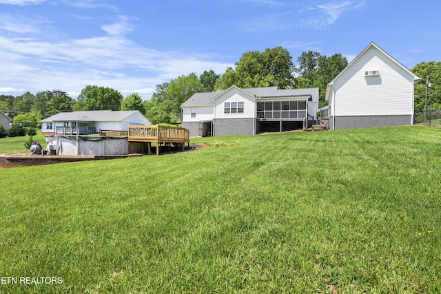 view of yard with a deck and a sunroom