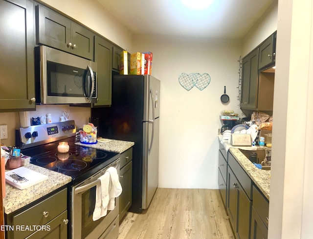 7003 Old Clinton Pike, Knoxville, TN 37921 - kitchen with a sink, light wood finished floors, light stone countertops, and stainless steel appliances