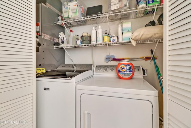 washroom featuring laundry area and washing machine and clothes dryer