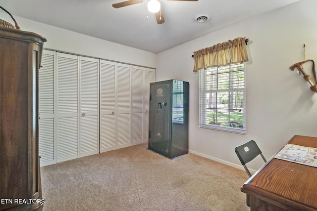 carpeted office featuring visible vents, a ceiling fan, and baseboards