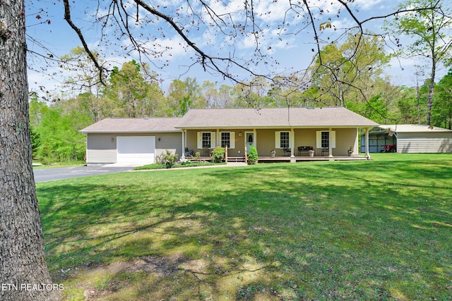 single story home with a porch, an attached garage, driveway, and a front yard