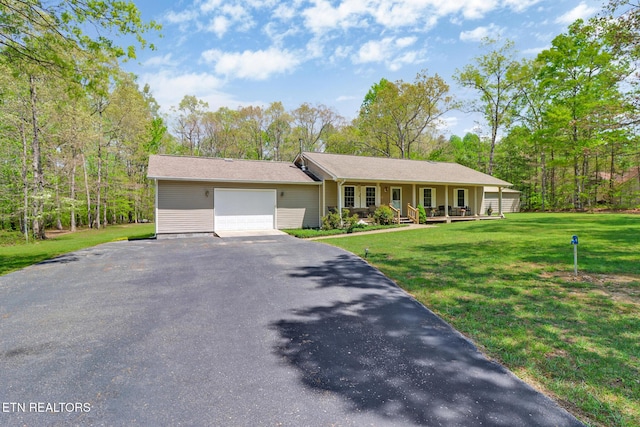ranch-style house with a garage, covered porch, a front lawn, and aphalt driveway