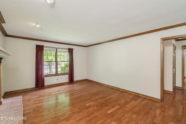 unfurnished living room with baseboards, ornamental molding, and light wood-style flooring