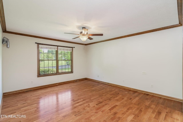 unfurnished room with baseboards, ceiling fan, ornamental molding, and light wood-style flooring