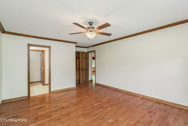 empty room featuring baseboards, a ceiling fan, and light wood finished floors