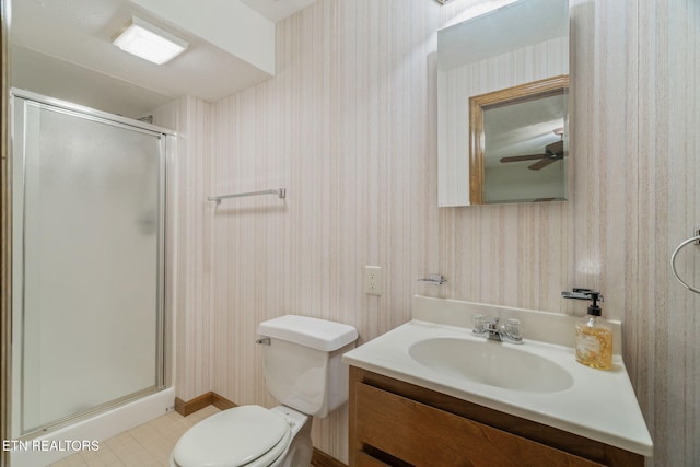 full bathroom featuring vanity, wallpapered walls, a shower stall, and toilet