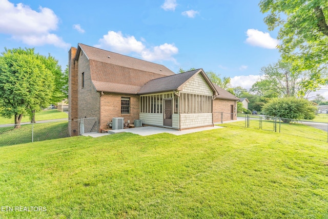 back of house with a chimney, a gate, a sunroom, and a patio area