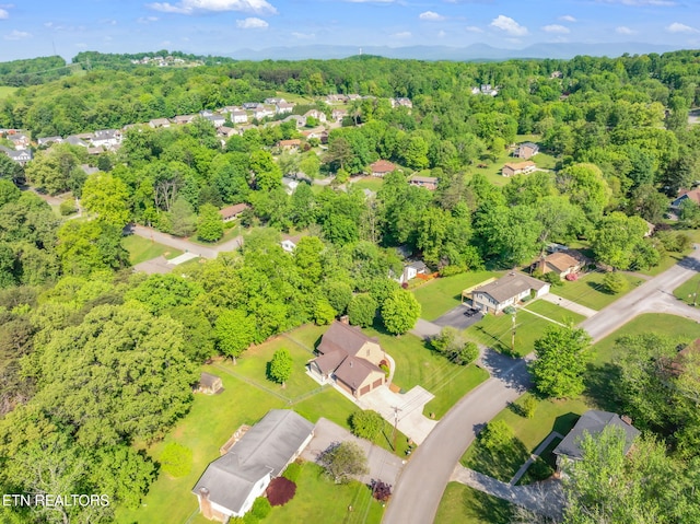 birds eye view of property featuring a view of trees