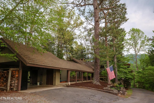 exterior space featuring driveway and an attached carport