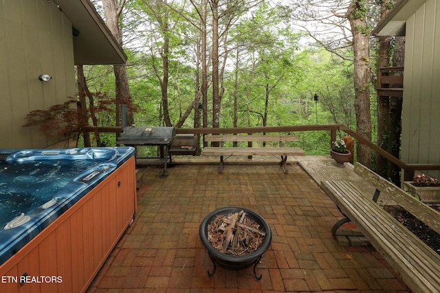 view of patio / terrace with a hot tub and grilling area