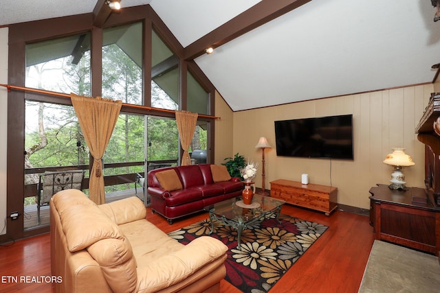 living area with high vaulted ceiling, beamed ceiling, and wood finished floors