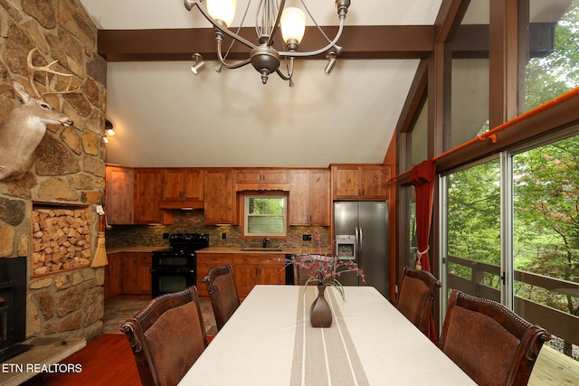dining area featuring a wealth of natural light, dark wood-style flooring, and a notable chandelier