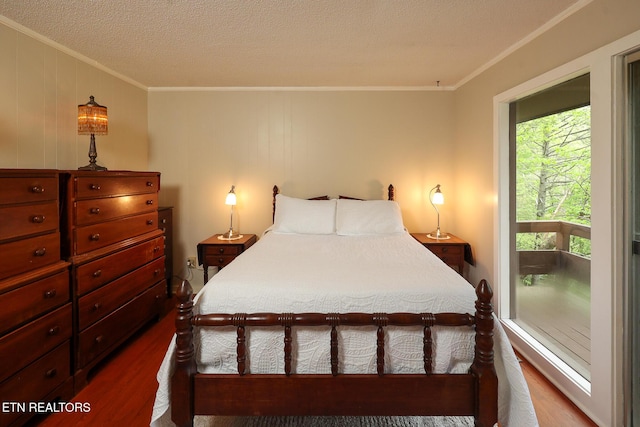 bedroom featuring crown molding, a textured ceiling, and dark wood-type flooring