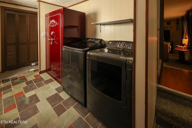 clothes washing area featuring washer and clothes dryer