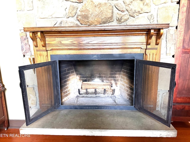 room details with a fireplace and wood finished floors