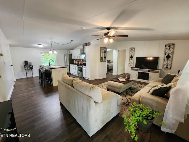 living area featuring baseboards, ceiling fan, dark wood-style floors, and lofted ceiling