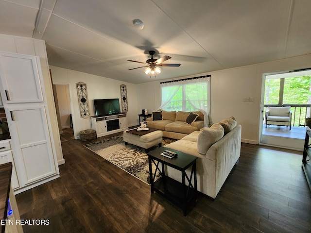 living area featuring baseboards, ceiling fan, dark wood-style flooring, and lofted ceiling