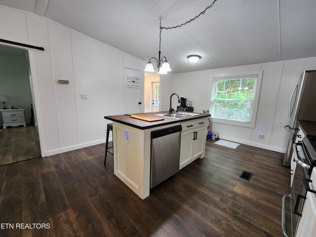 kitchen featuring dishwasher, a sink, a notable chandelier, wood counters, and dark wood-type flooring