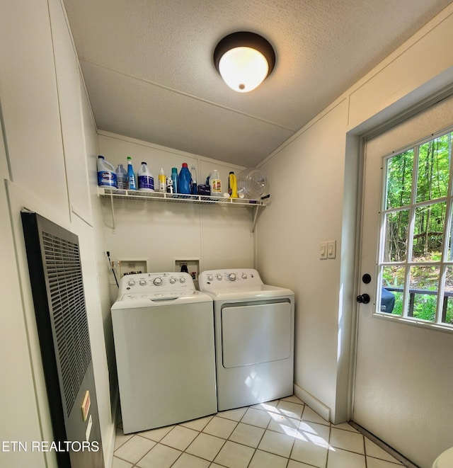 laundry area with plenty of natural light, light tile patterned flooring, independent washer and dryer, and a heating unit