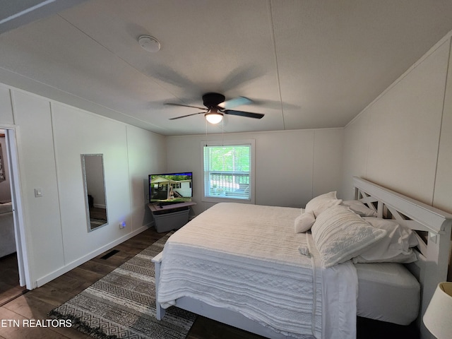bedroom with a ceiling fan, visible vents, and dark wood-style floors