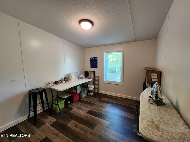 home office featuring dark wood finished floors and a textured ceiling