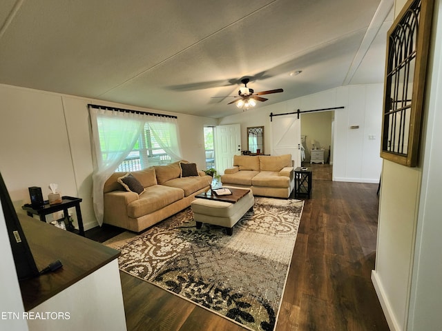living area with ceiling fan, a barn door, baseboards, dark wood-style floors, and lofted ceiling