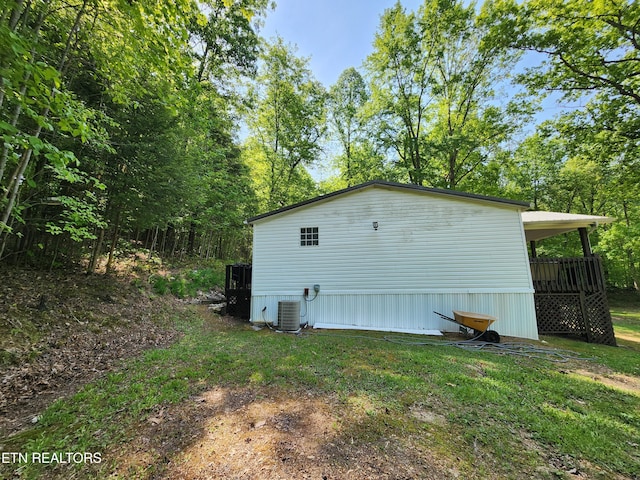 view of property exterior featuring a lawn and cooling unit