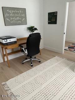 office space with baseboards and wood finished floors