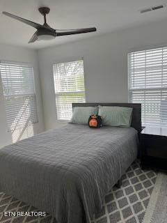 bedroom with a ceiling fan and visible vents